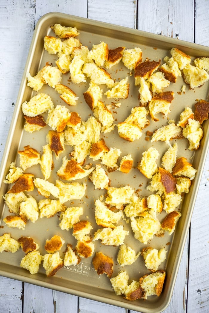 chunks of brioche on a baking sheet.