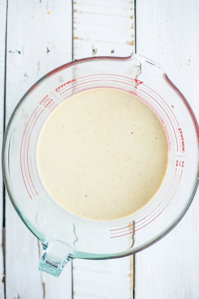 custard mixture in a glass mixing bowl.