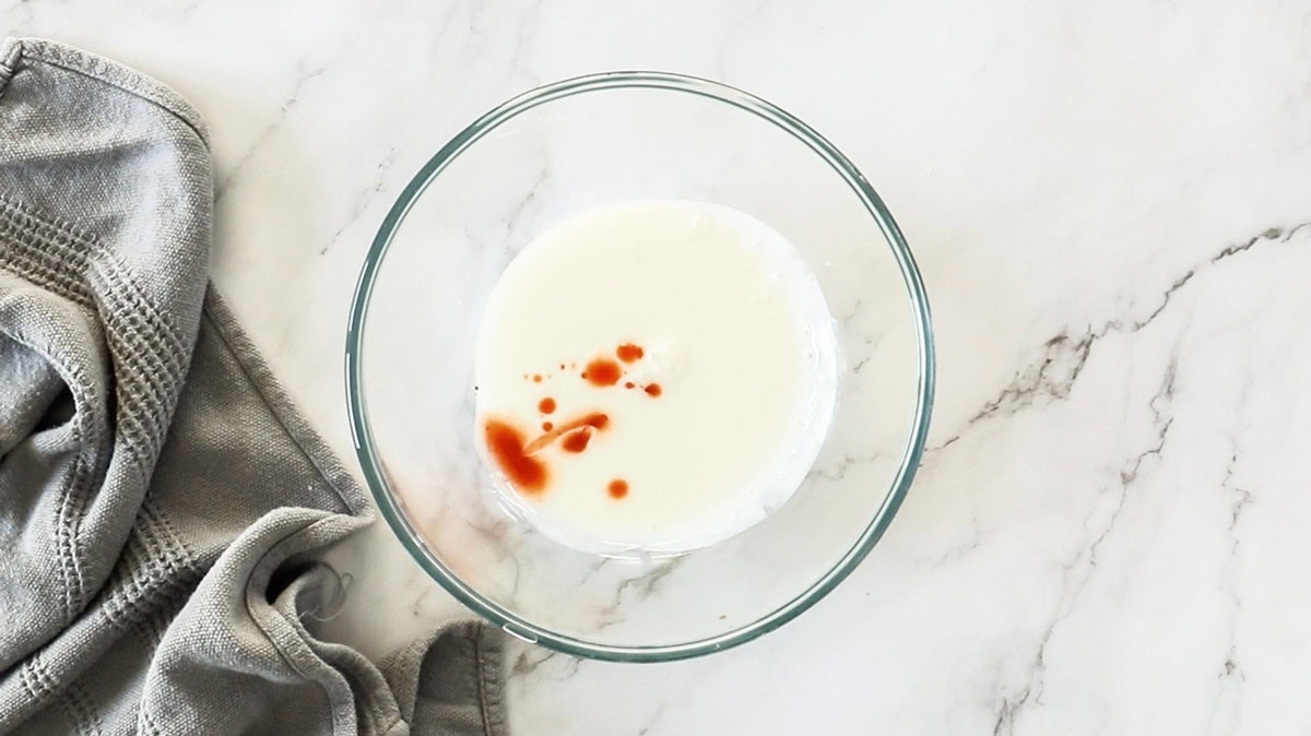 buttermilk and hot sauce in a glass bowl.