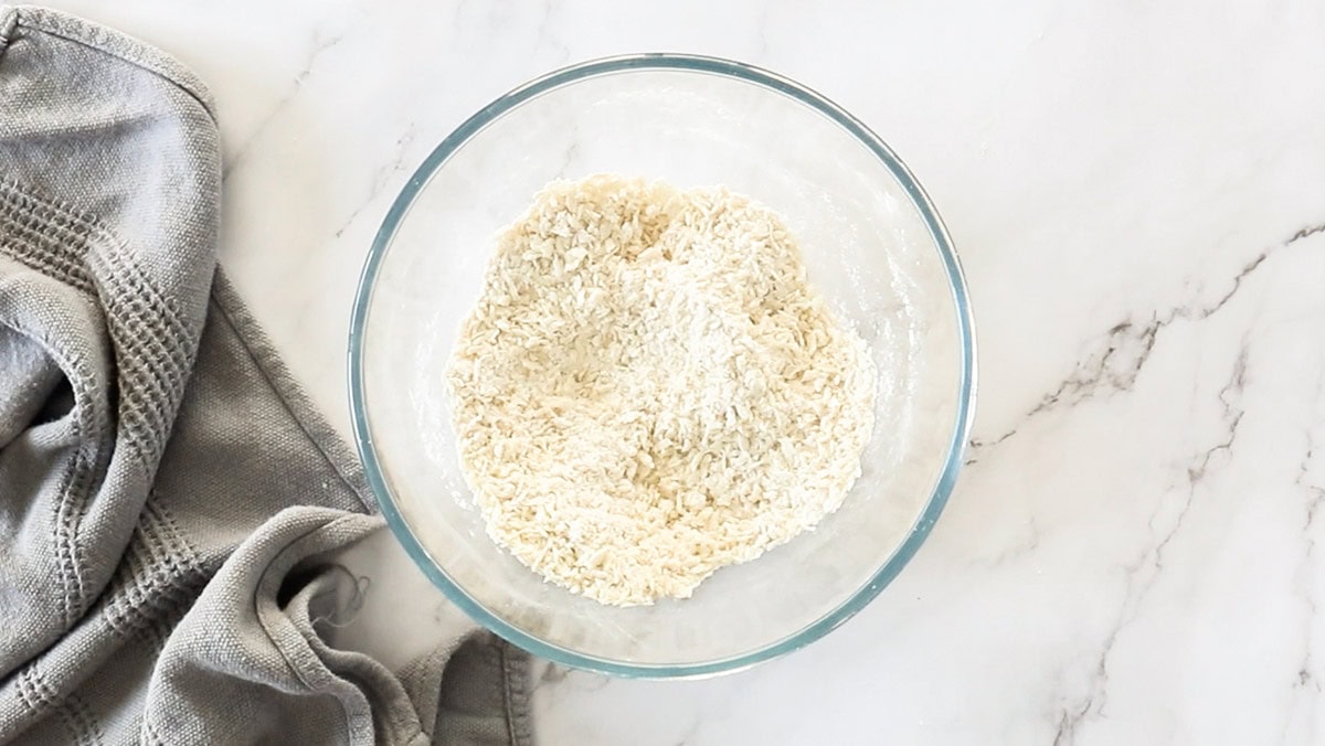 a glass bowl with flour and panko.