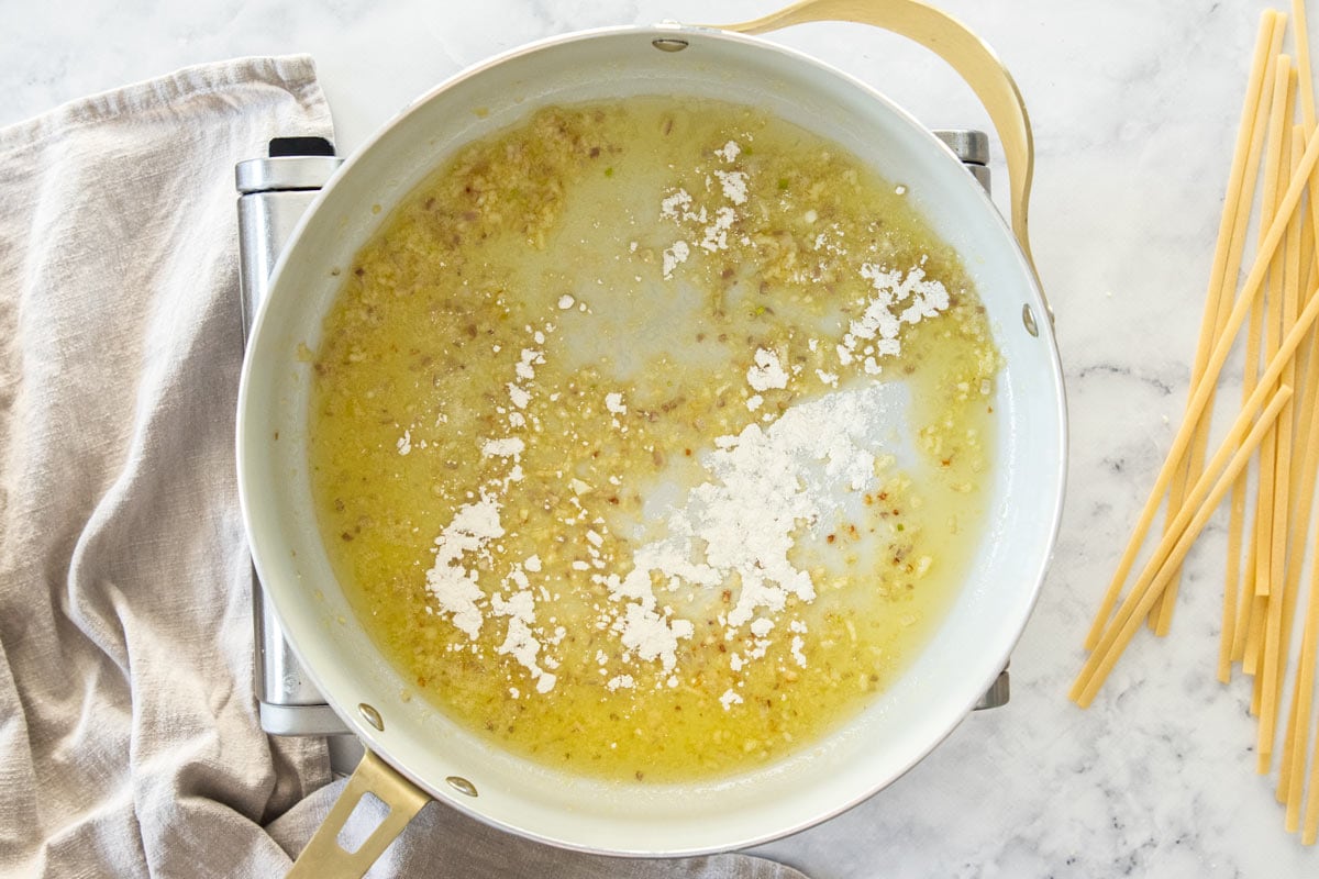 butter and shallots in a white skillet with flour.