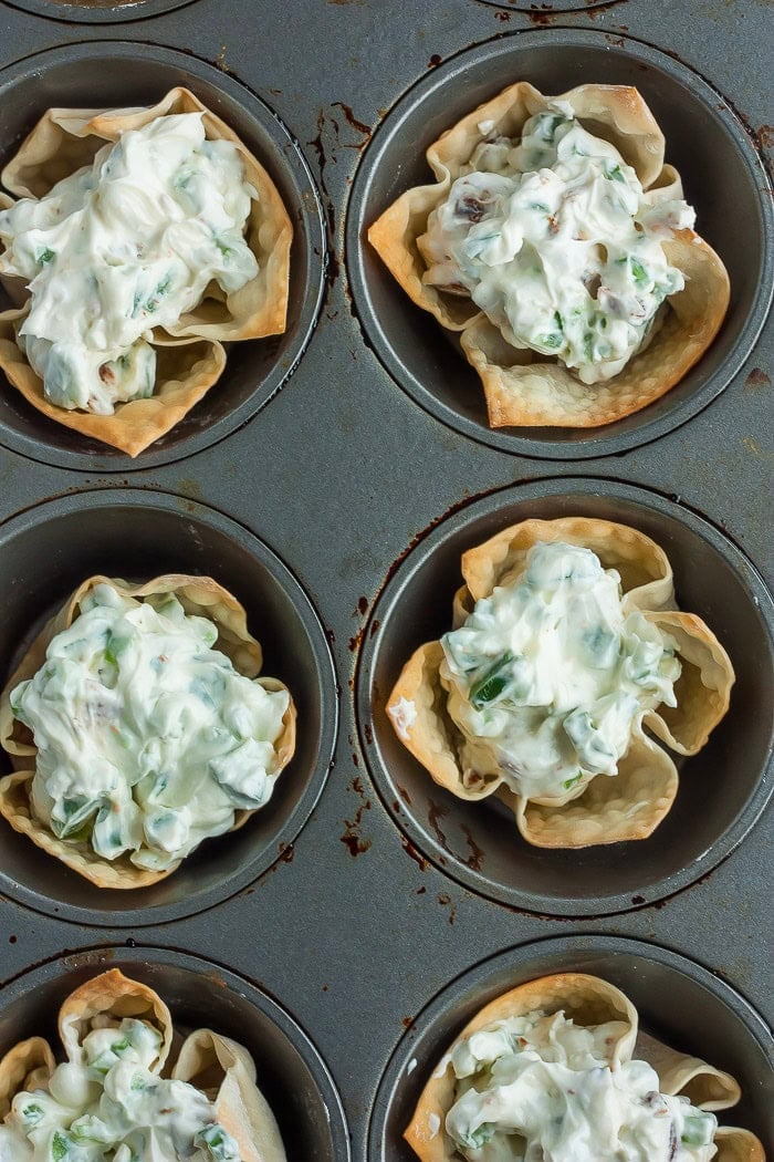 jalapeno popper mix in pastry cups in muffin tins.