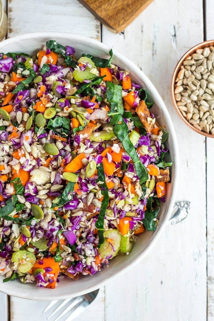 colorful rainbow vegetable salad in a white bowl.
