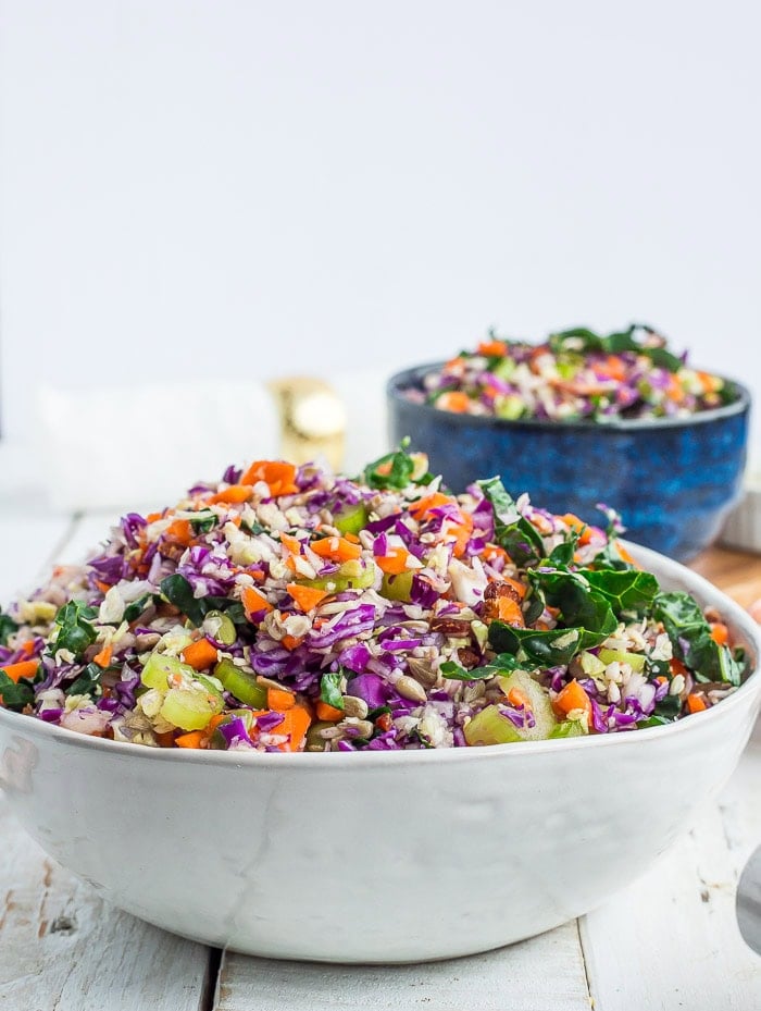 a side profile of chopped cabbage salad in white and blue bowls.