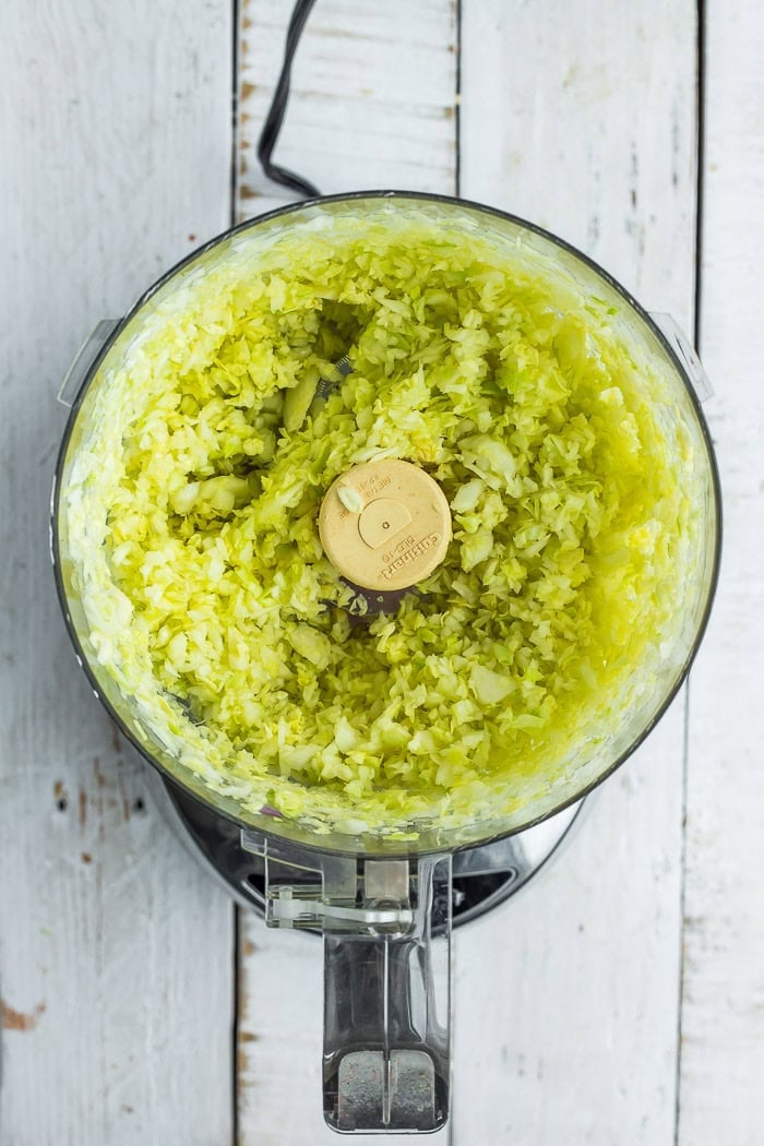 green cabbage in a food processor after chopping.