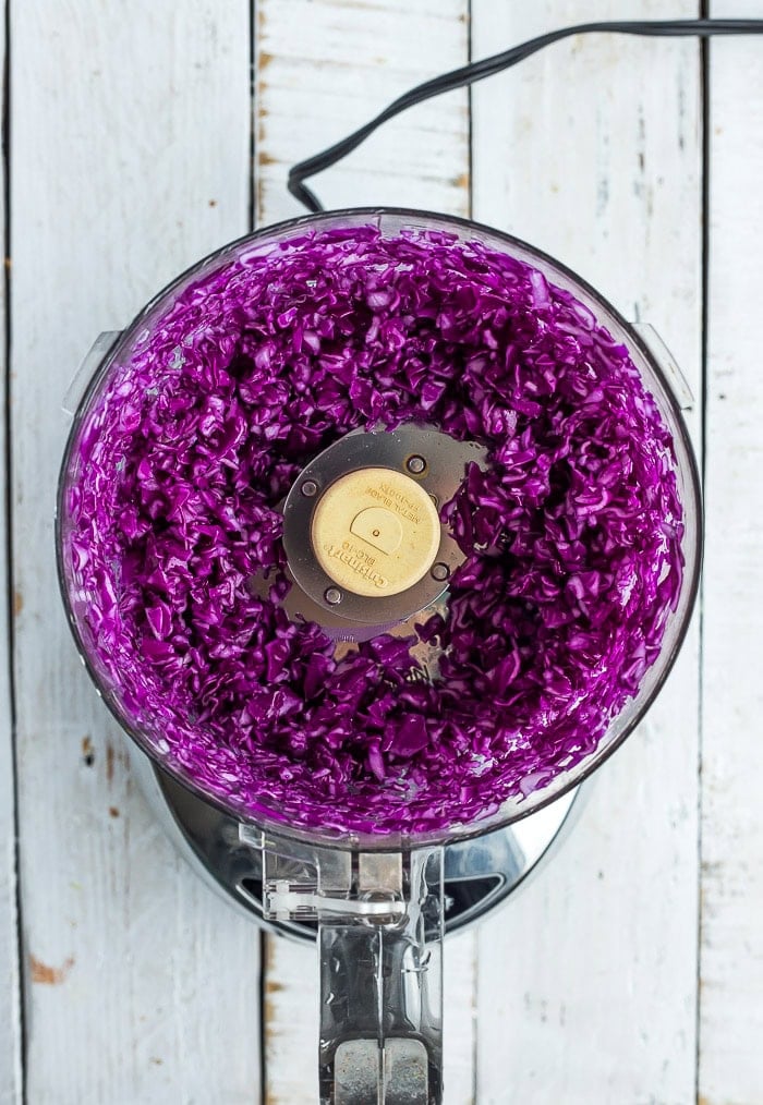 purple cabbage in a food processor after chopping.