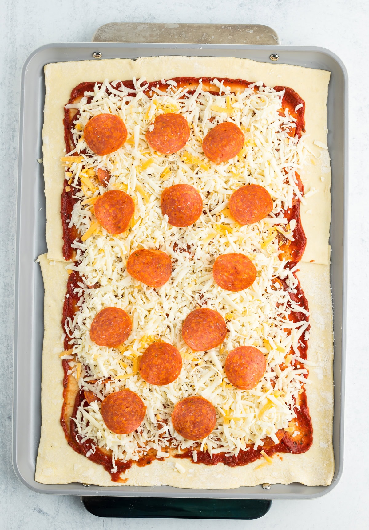 pepperoni and cheese on top of unbaked dough.
