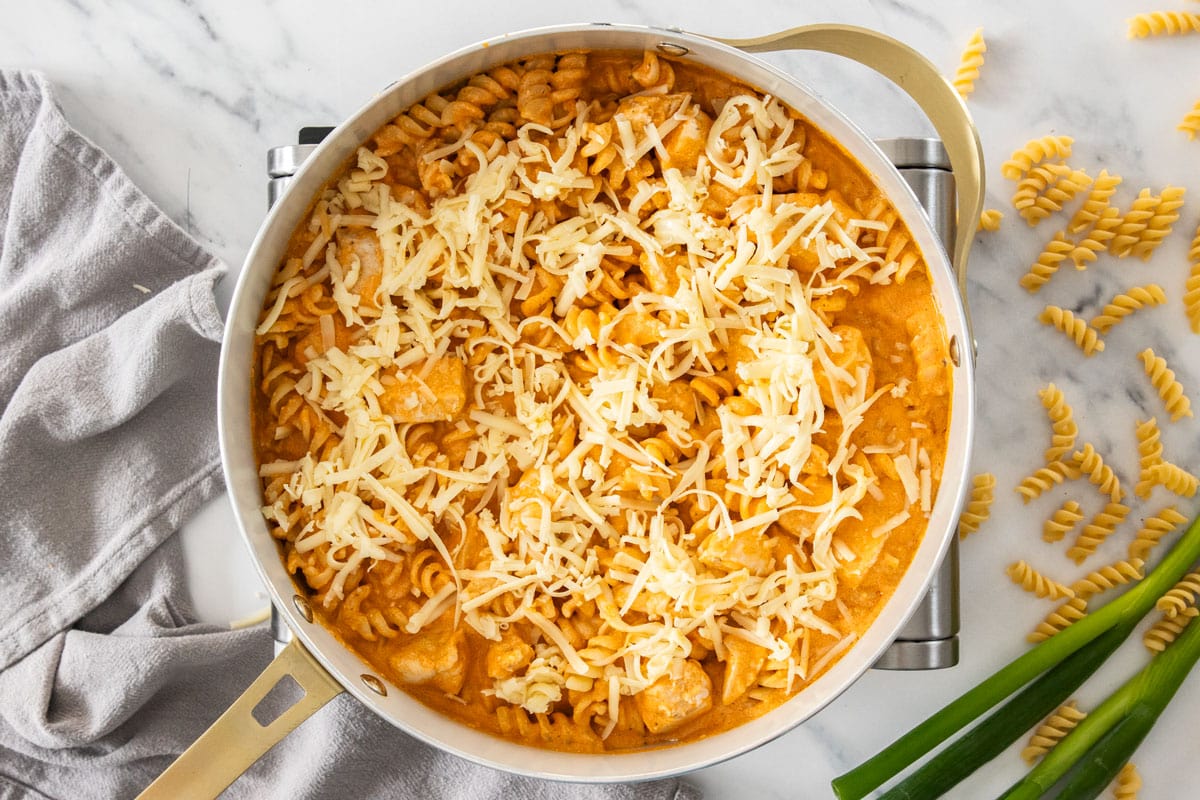 cheese and other ingredients being cooked in a skillet.