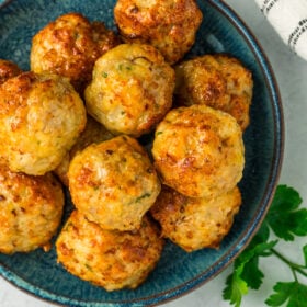juicy chicken air fryer meatballs on a blue plate.