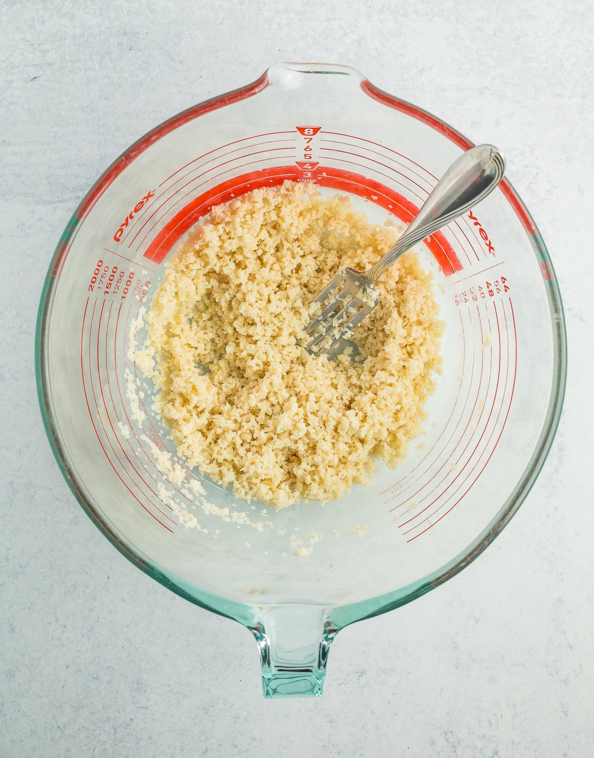 breadcrumbs mixed with milk in a glass bowl.