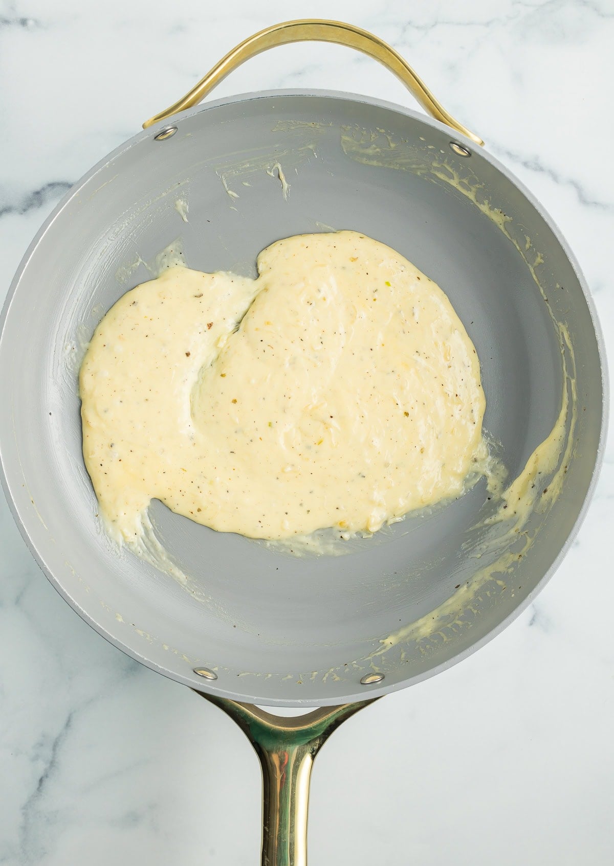 alfredo sauce in a skillet.