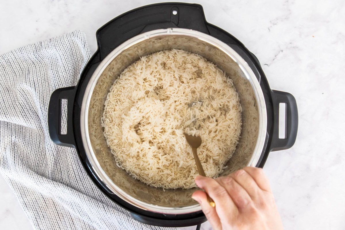 a fork being used in a pressure cooker.