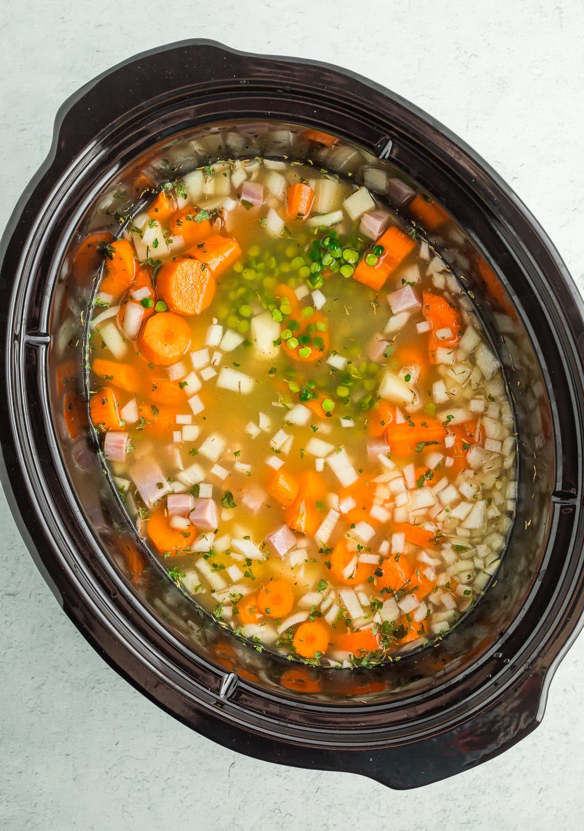 a crockpot full of uncooked ingredients.
