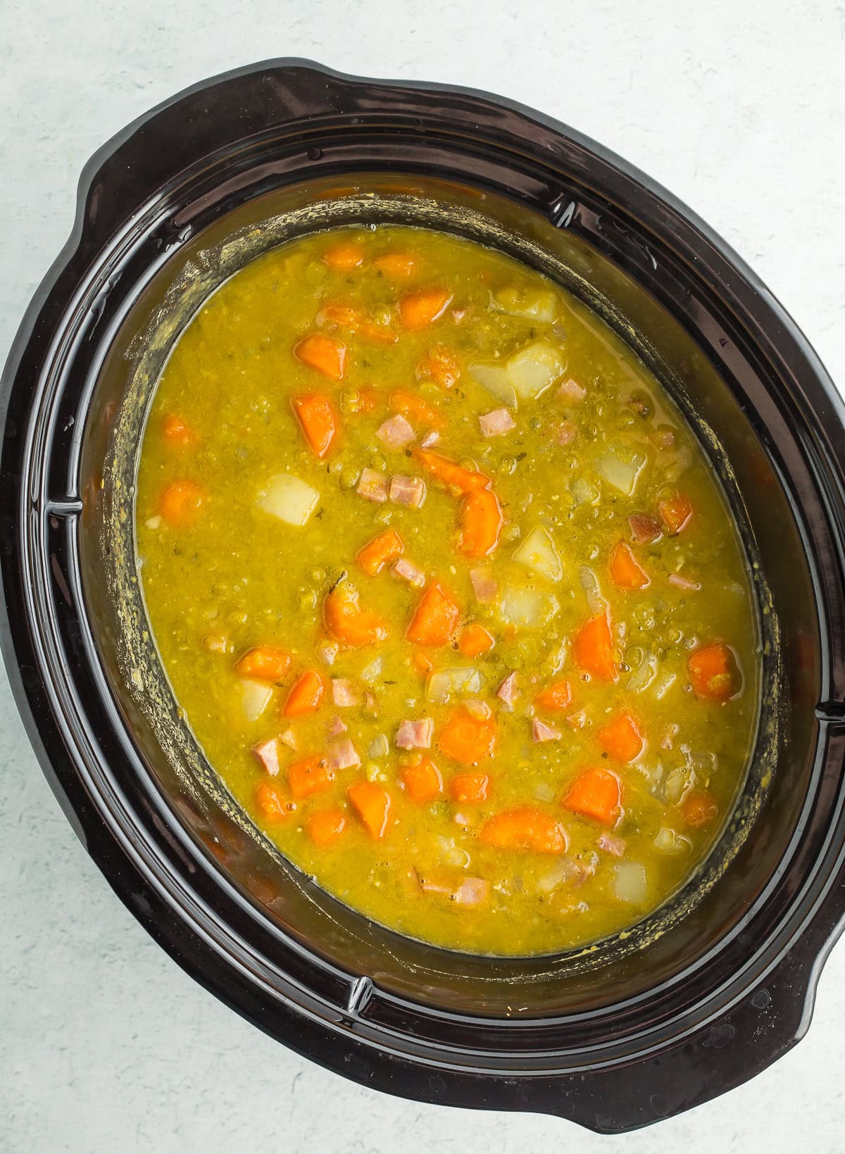 a crockpot full of ingredients cooking.