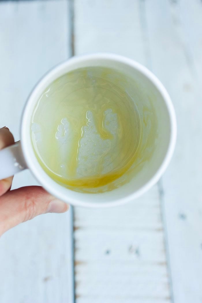 melted butter in a white cup.