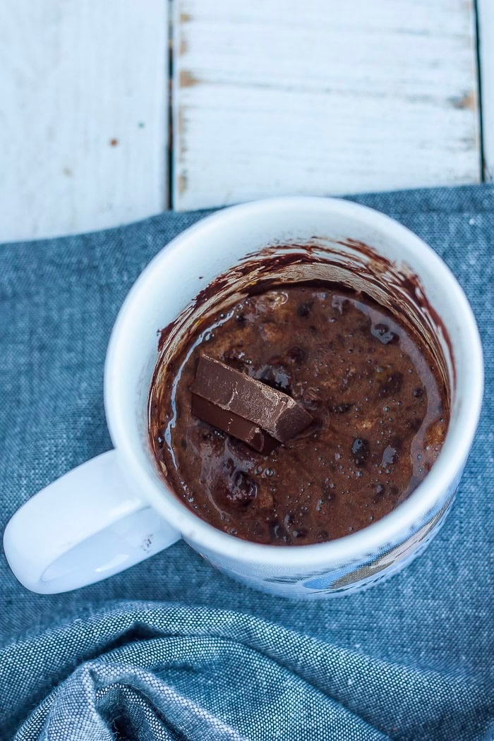 a square of chocolate in a white cup.