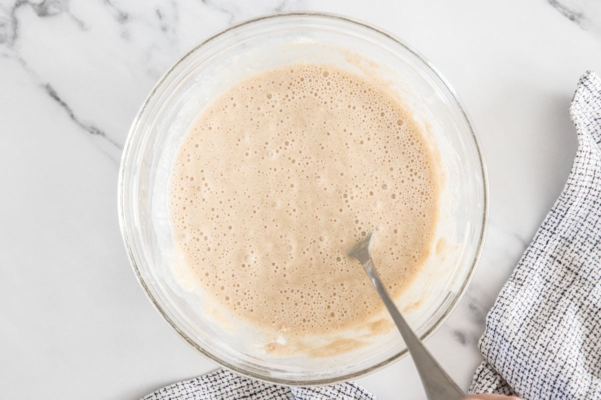 uncooked batter in a glass bowl with a spoon.