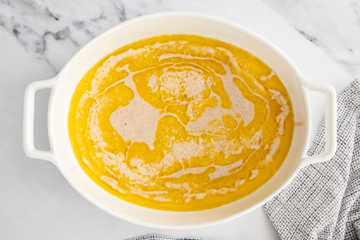 melted butter in a white baking dish.