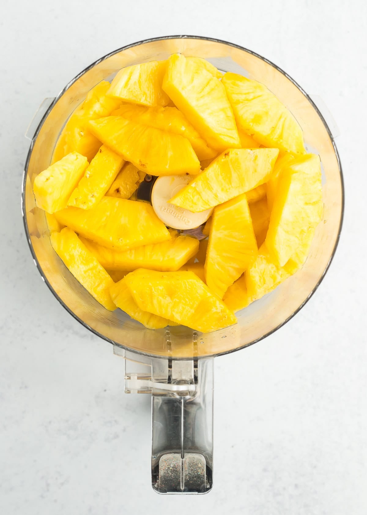 slices of pineapple in a food processor.