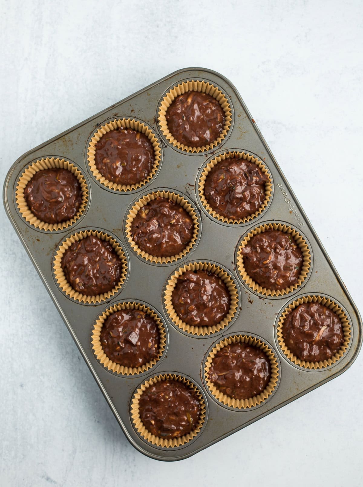 unbaked batter in a muffin tray.