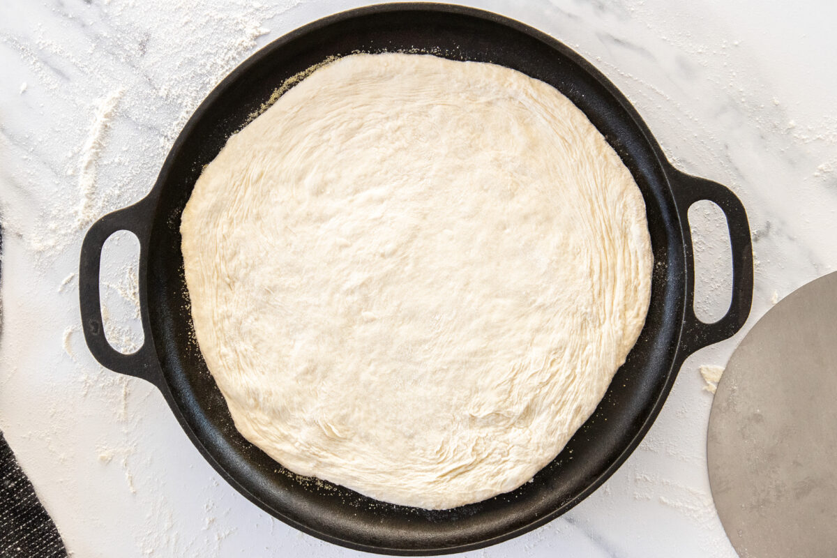 uncooked dough on a cast iron pan.