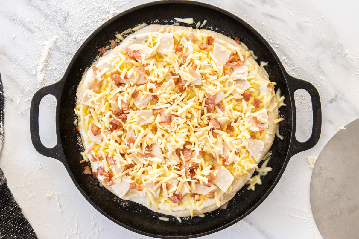 toppings on an unbaked pizza.