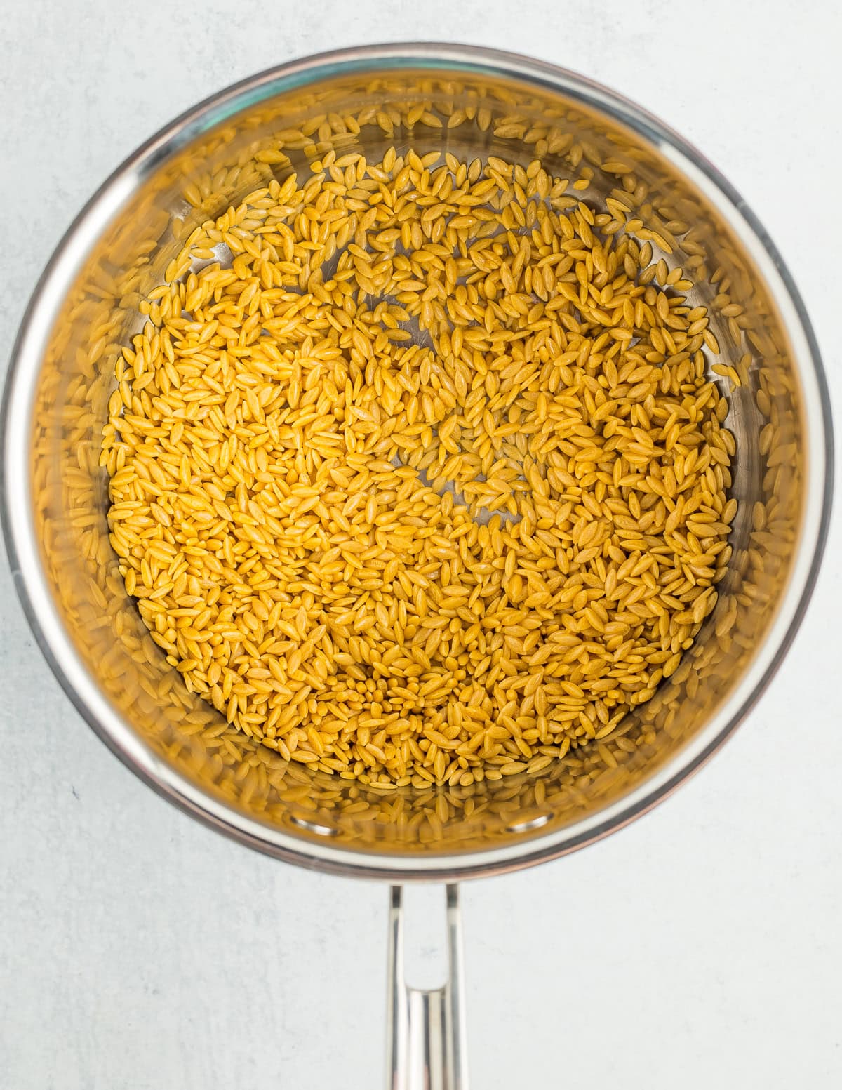 olive oil and orzo in a saucepan.