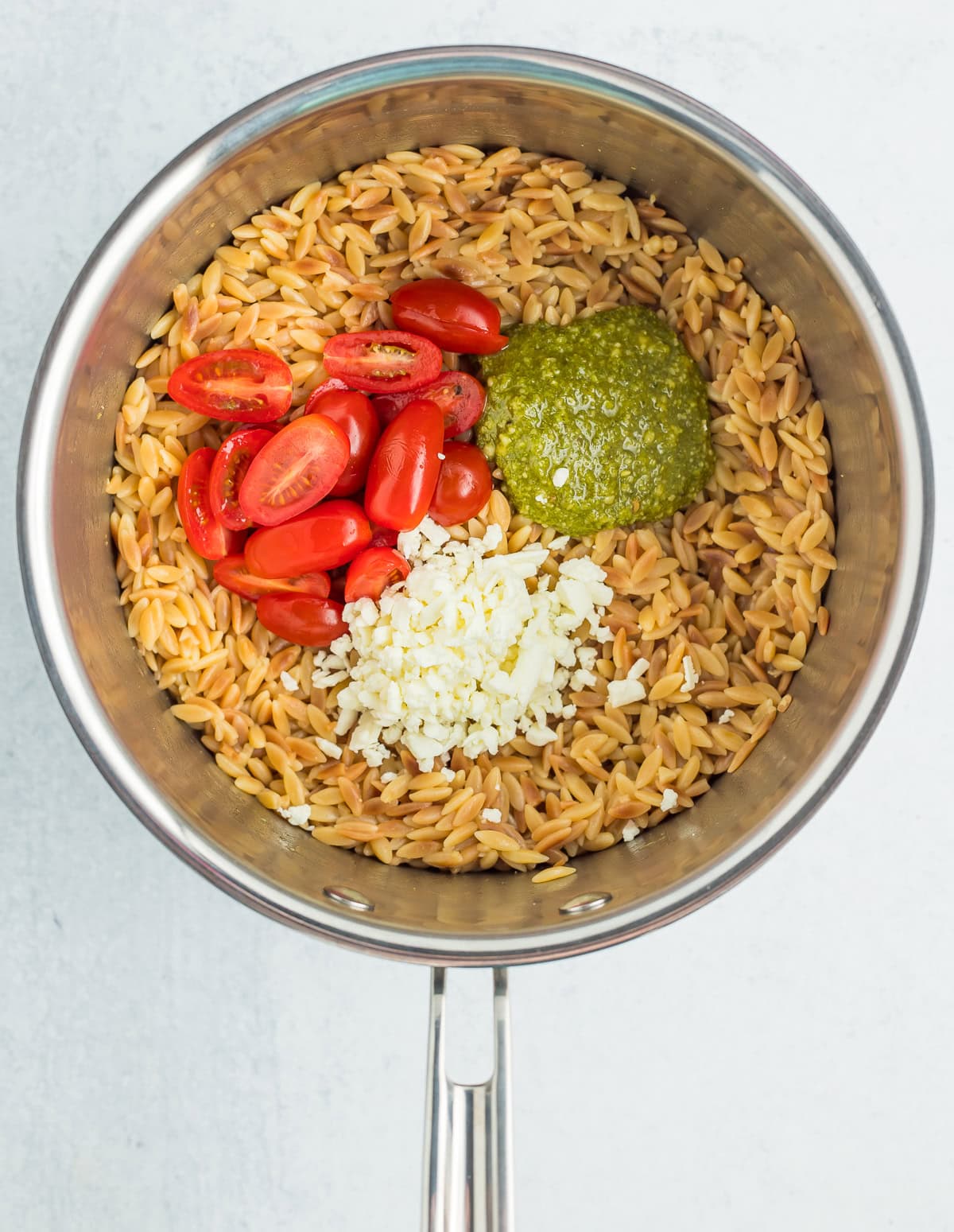 ingredients and cooked pasta in a saucepan.