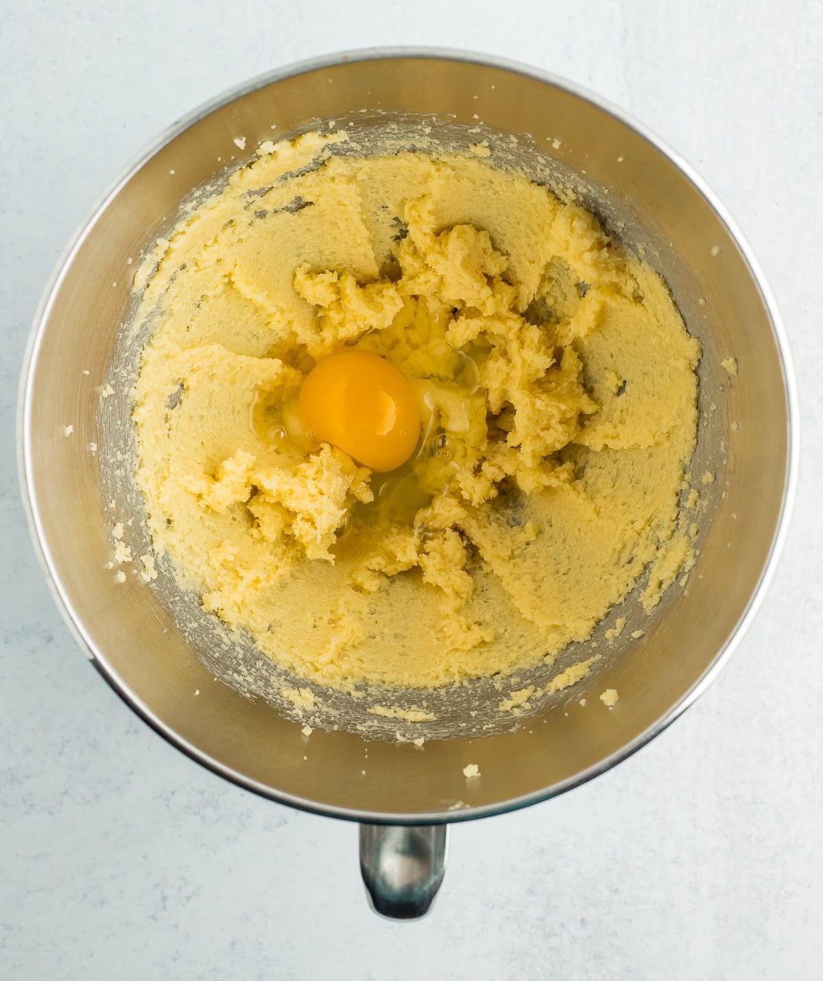 batter and an egg in a mixing bowl.