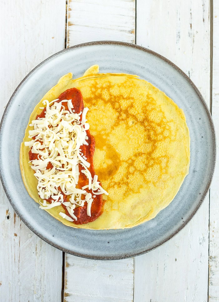 red sauce and shredded mozzarella on top of a base.