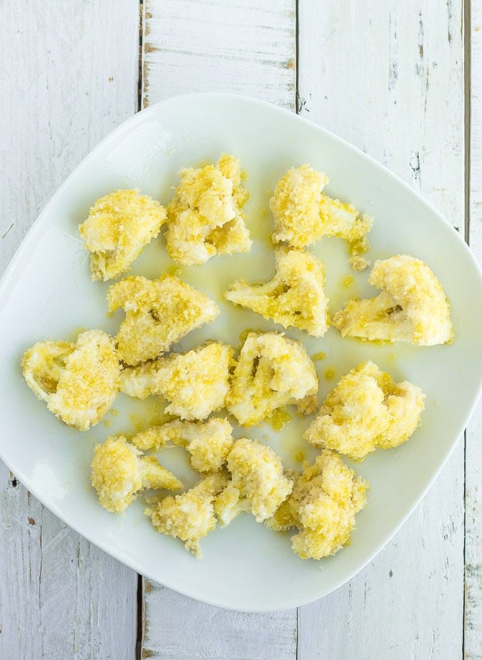uncooked cauliflower on a white plate.