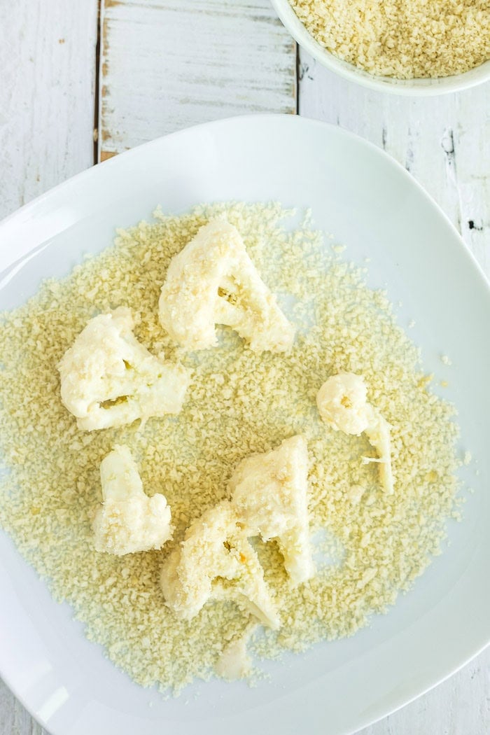 battered cauliflower on a plate with panko breadcrumbs.
