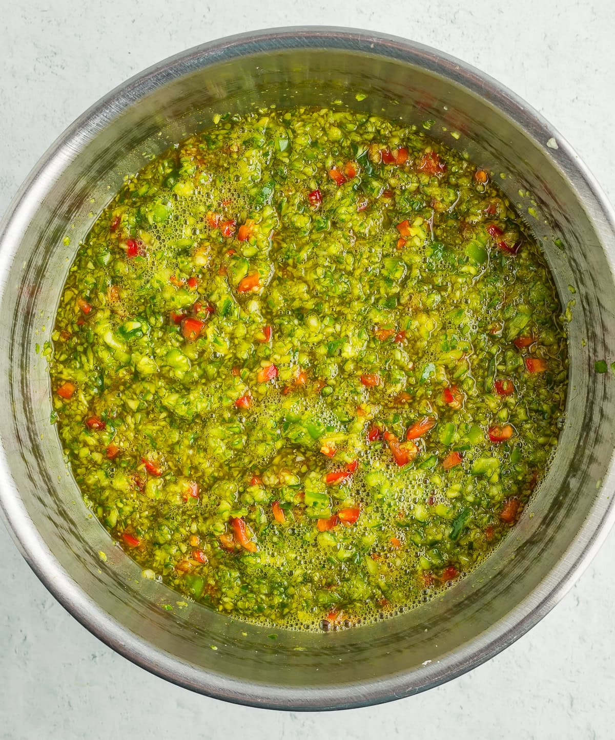 chopped vegetables in a metal bowl with brine.