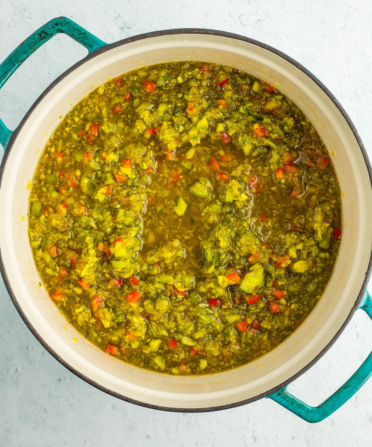 chopped vegetables in a blue Dutch oven with brine.