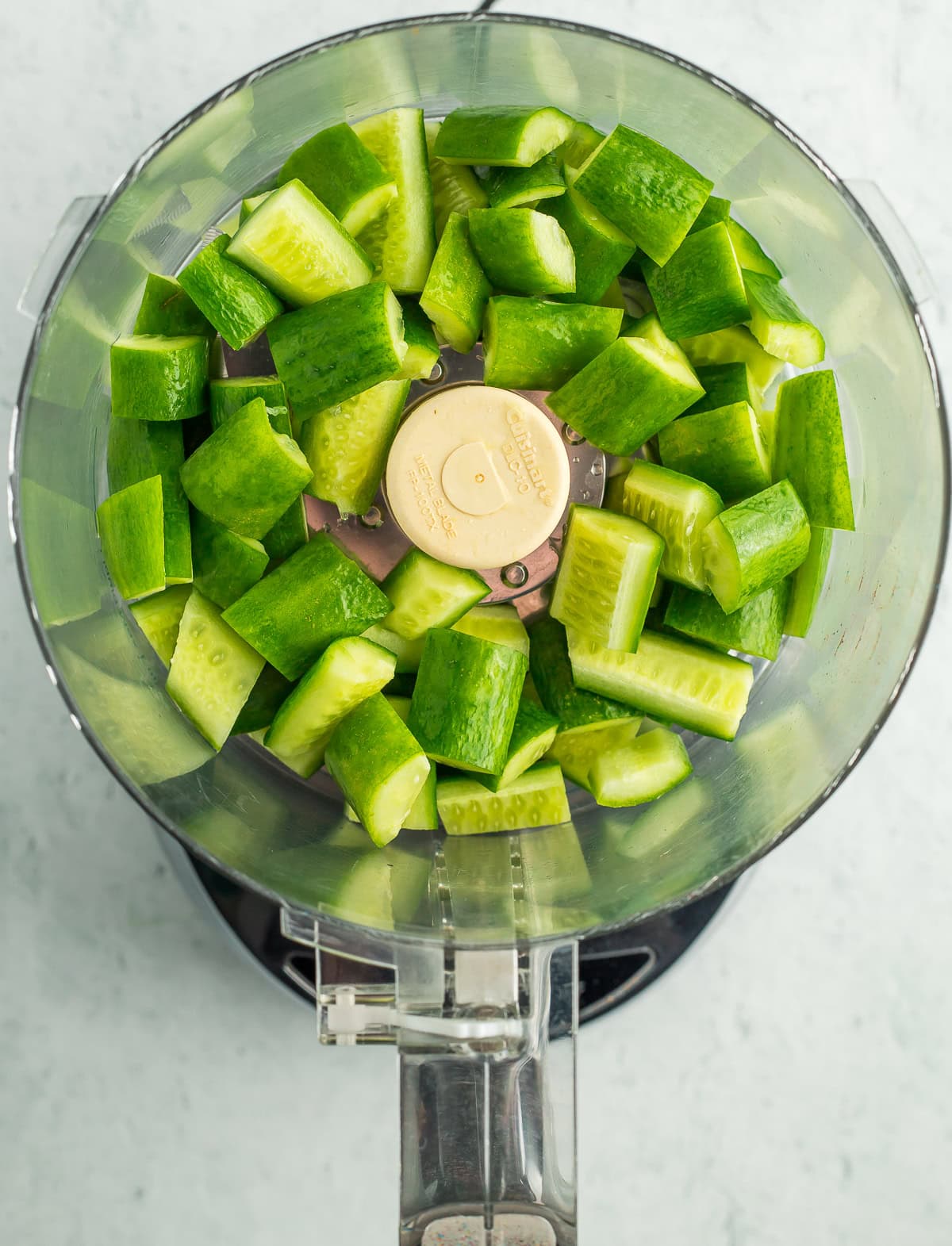 cubes of cucumbers in a food processor.
