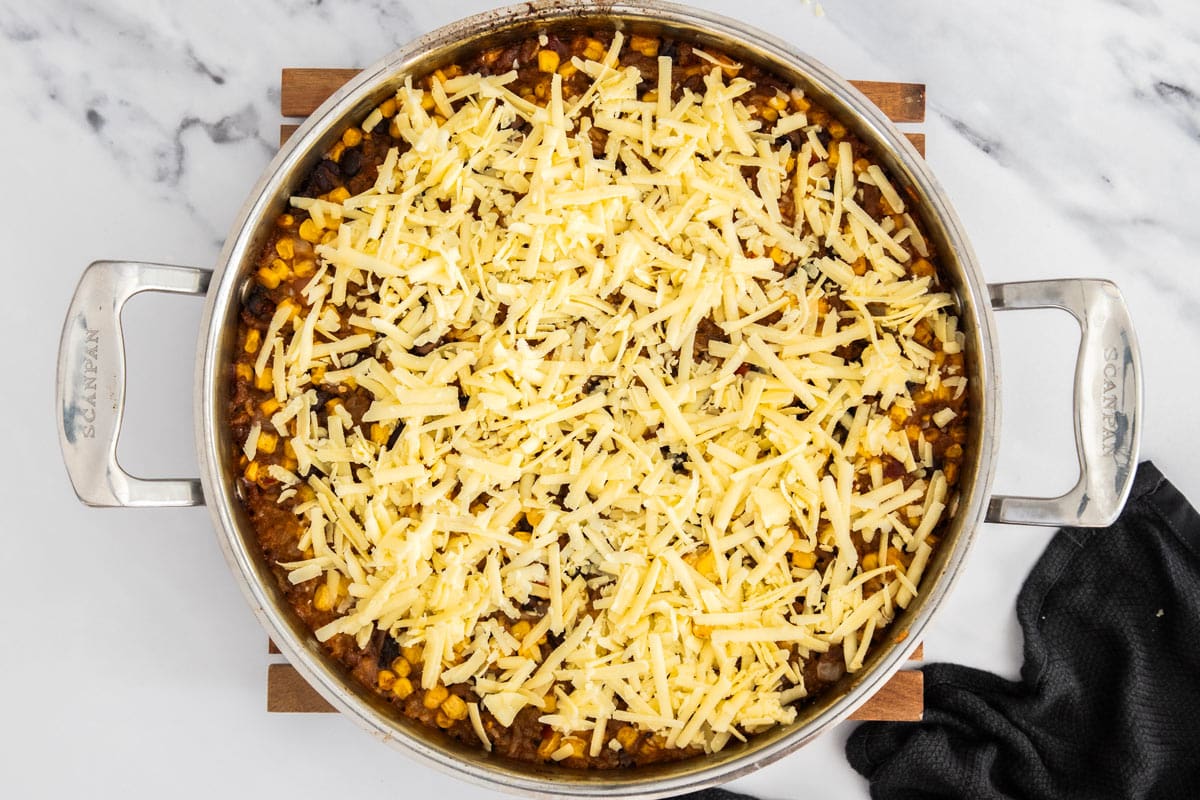 shredded cheese on top of an unbaked casserole