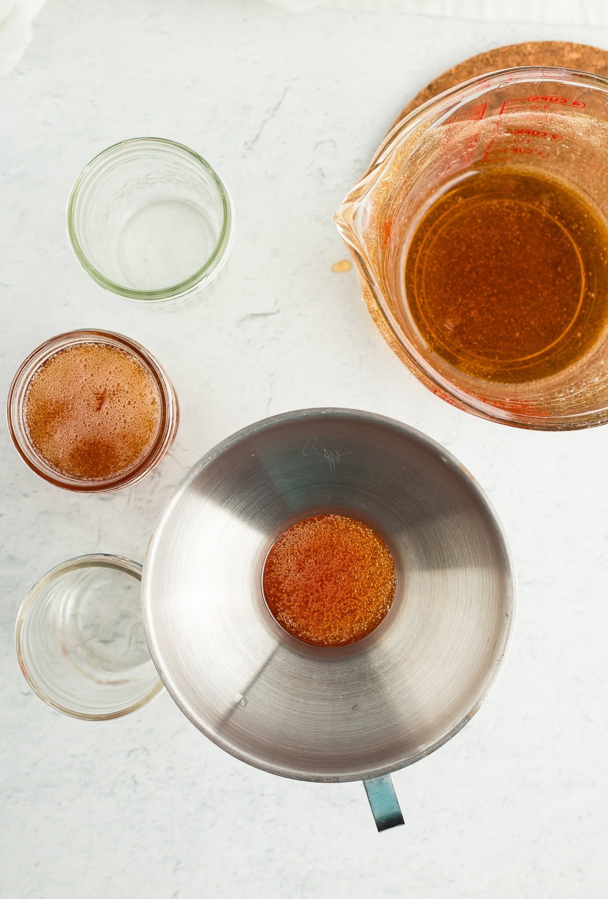 canning jars being filled with jelly.