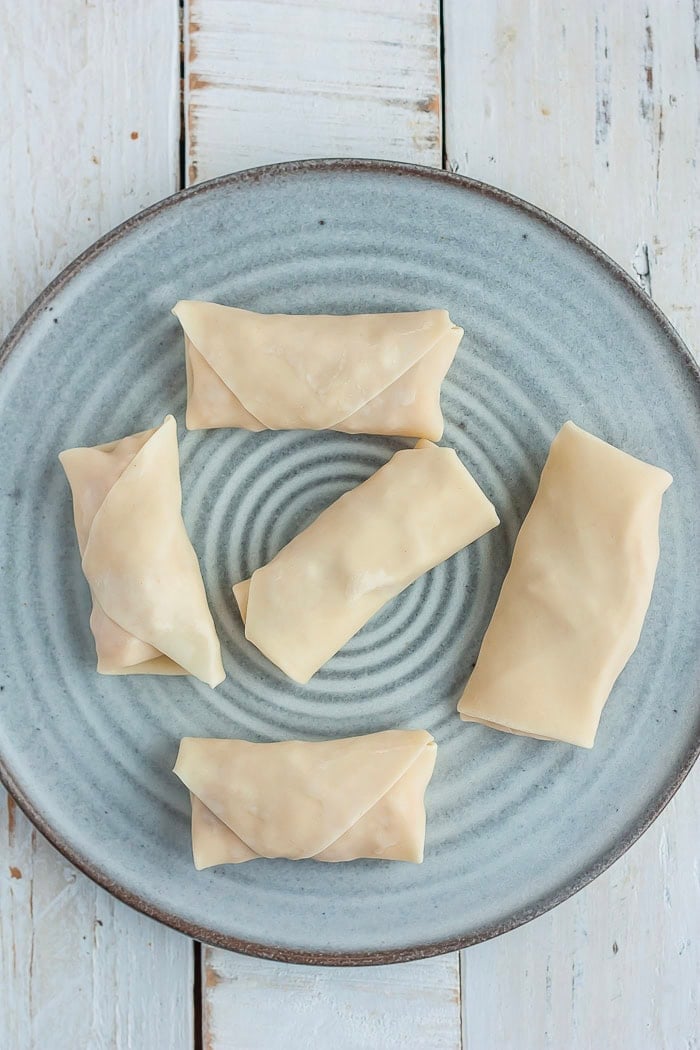 instructions showing how to wrap a dessert egg roll.