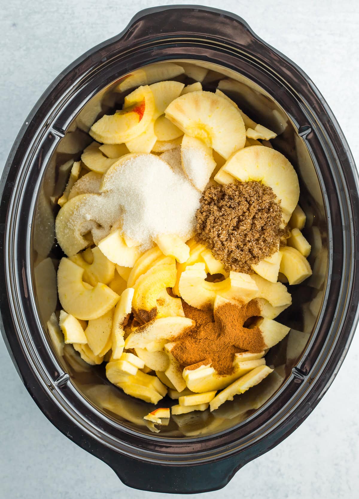 ingredients in a black slow cooker.