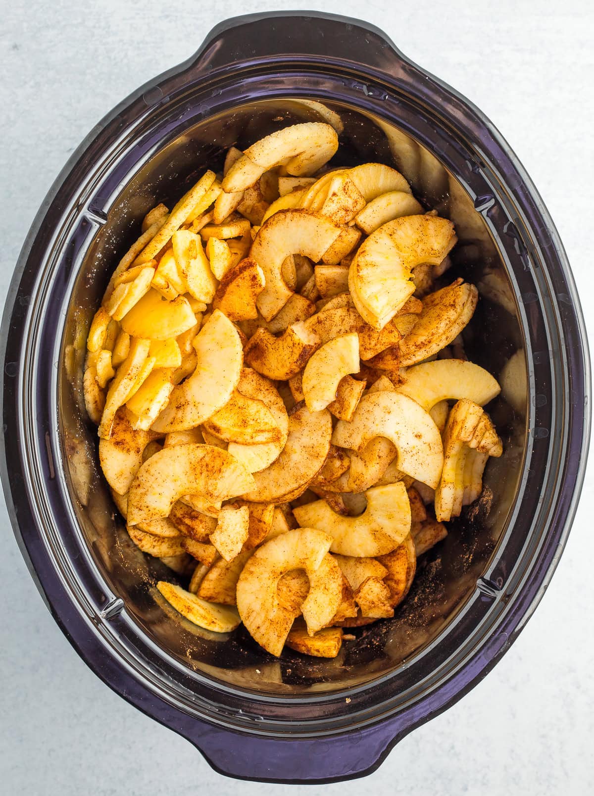 sliced apples in a crockpot.
