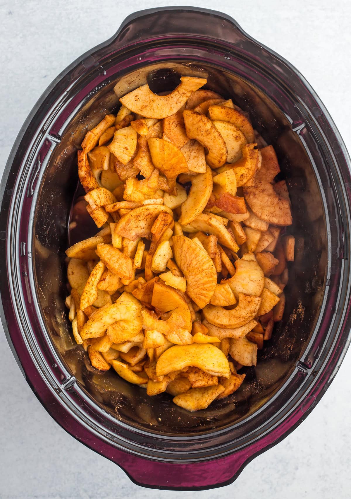softened sliced apples in a crockpot.