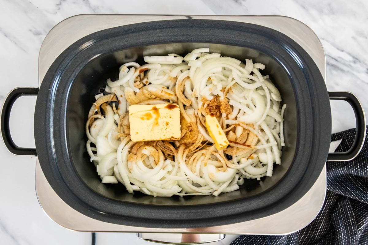 sliced onions butter, and garlic in a crockpot.