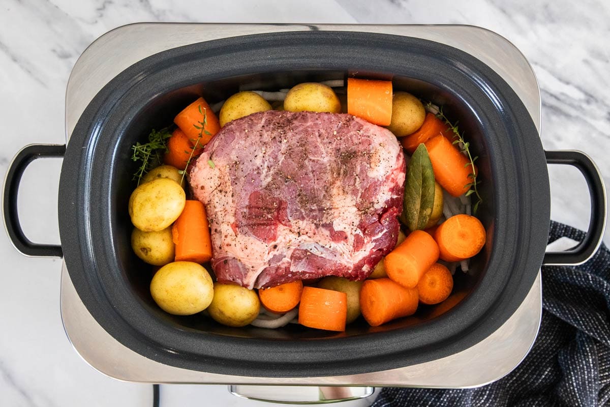 veggies and beef in a crockpot.
